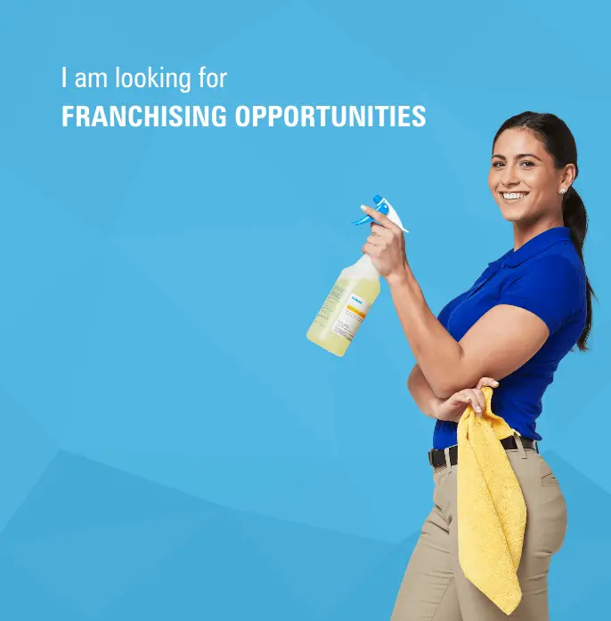 Female commercial cleaner with a sanitizer in hand